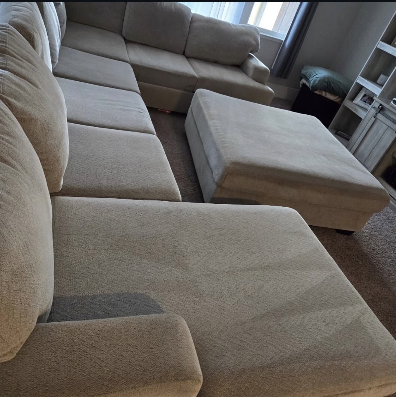 Beige sectional couch freshly cleaned with visible grooming lines